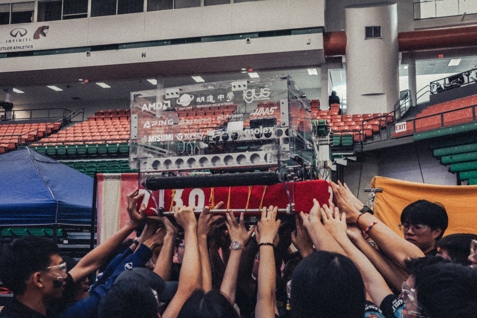 The team lifting the 2026 robot, sponsor decals on display